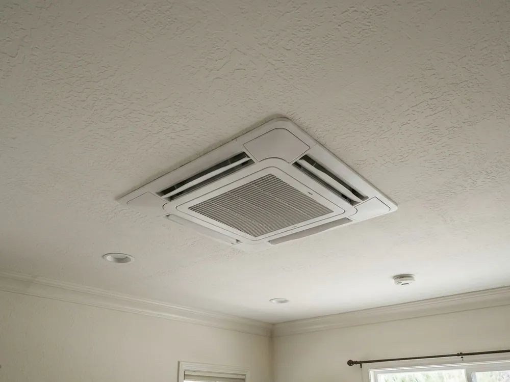 Ceiling-cassette grille in a finished ceiling.