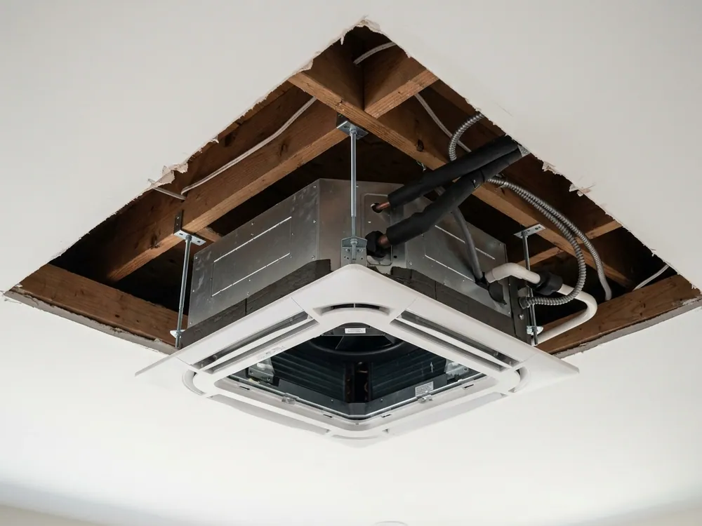 Ceiling cassette body and supports visible before ceiling closure.