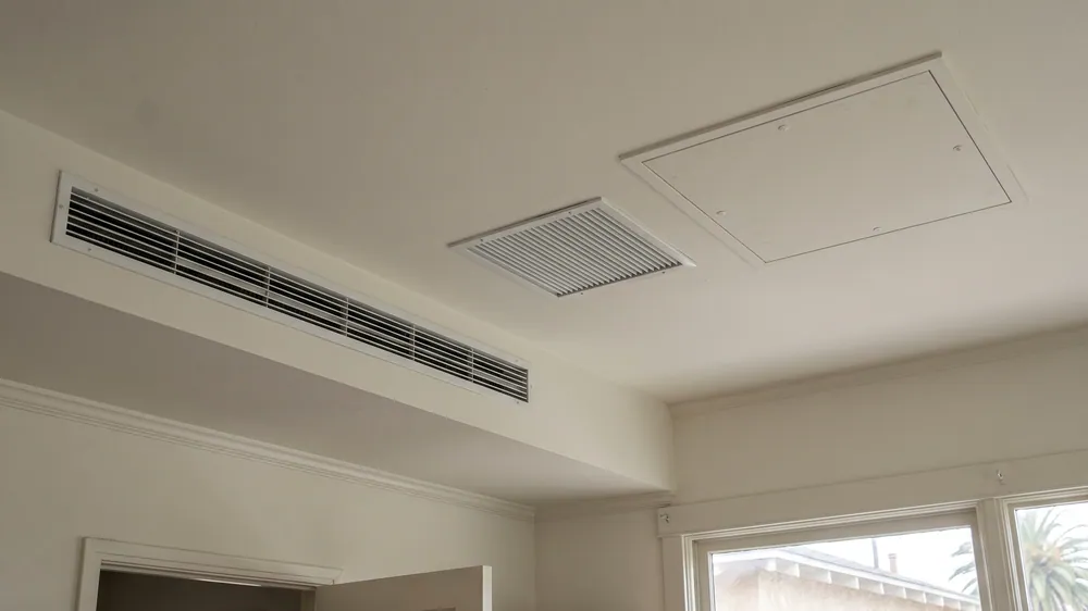 Supply grille, return grille and service-access panel for a concealed system.