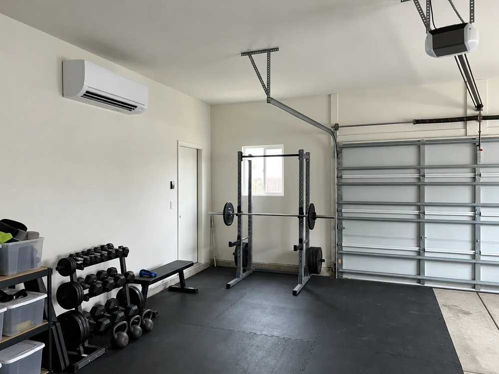 Wall-mounted mini-split in a garage workout space.